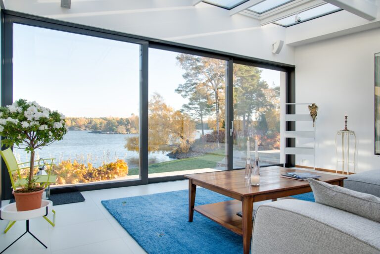 A beautiful view of a blue lake captured from the inside of a villa